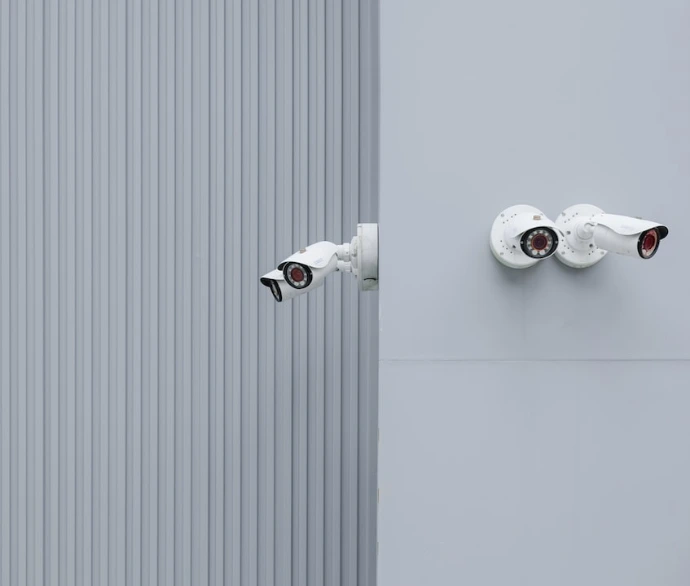 white camera grey wall